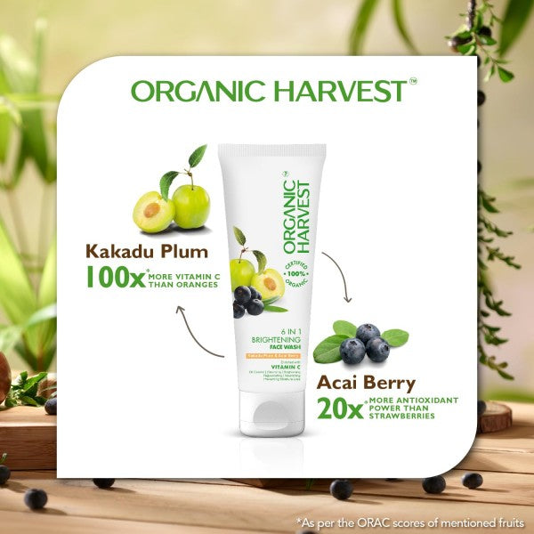 Organic Harvest skincare product with Kakadu Plum and Acai Berry ingredients on a wooden surface with greenery.